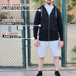 A head to toe shot of a tall slim guy standing in a tennis court, smiling and wearing an XL tall slim black zip up hoodie.