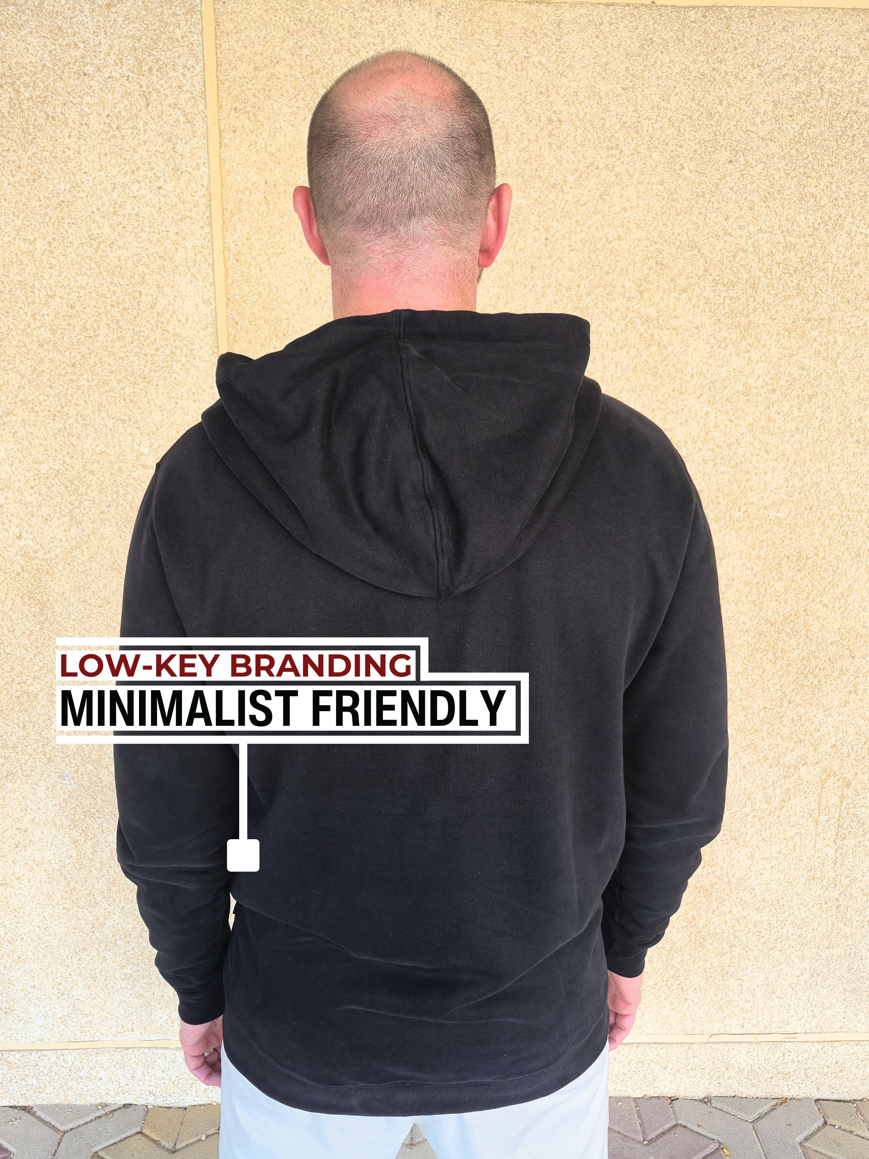 A shot from behind of a tall slim guy wearing an XL tall slim black hoodie.