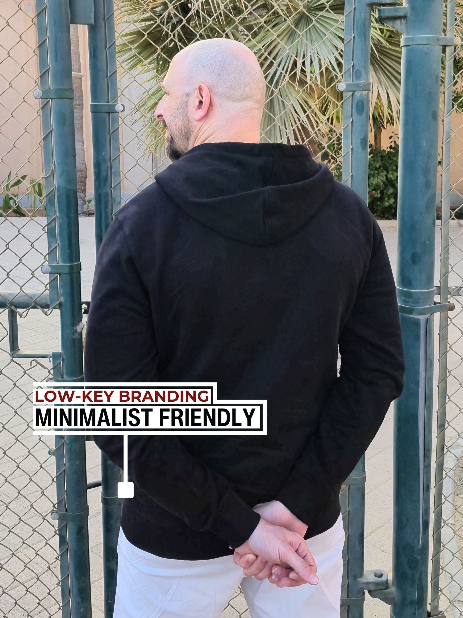 A shot from behind of a tall slim guy wearing an XL tall slim black hoodie.
