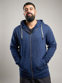 A tall and broad guy standing in a studio and wearing a 2XL Tall dark navy zip-up hoodie.