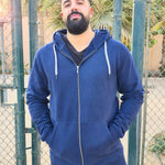 A tall and broad guy standing in a tennis court and wearing a 2XL Tall dark navy zip-up hoodie.