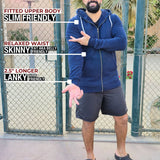 A head to toe shot of a tall and broad guy standing in a tennis court and wearing a 2XL Tall dark navy zip-up hoodie.