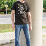 A head to toe shot of a tall skinny guy wearing a black tall slim t-shirt.