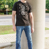 A head to toe shot of a tall skinny guy wearing a black tall slim t-shirt.