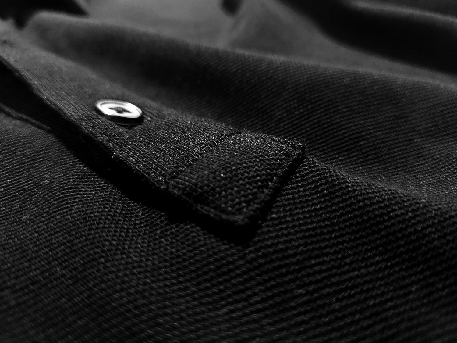 Close up of a polo placket and the organic cotton pique knit.