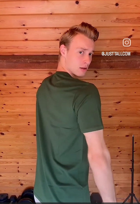 A 6'9" tall athletic guy wearing a green tall slim graphic t-shirt.