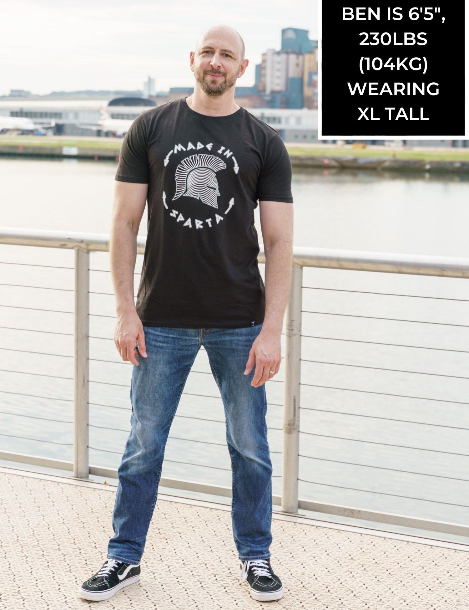 A tall skinny guy wearing a sparta tall slim t-shirt