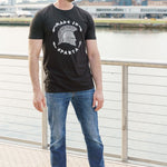 A head to toe shot of a tall skinny guy wearing a tall slim graphic t-shirt.