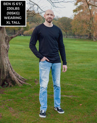 Thumbnail for A head to toe shot of a tall athletic guy in a park wearing a black long sleeve tall t-shirt.