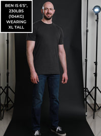 Thumbnail for A head to toe shot of a tall and slim guy in the studio wearing a charcoal XL tall slim t-shirt.