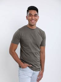 Thumbnail for A tall slim guy wearing a dark grey medium tall t-shirt, hand in pocket.