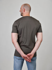 Thumbnail for A shot from behind of a tall and slim guy in the studio and wearing a dark grey XL tall slim v-neck t-shirt.