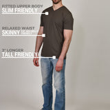 A head to toe shot of a tall and slim guy in the studio wearing a dark grey XL tall slim v-neck t-shirt.