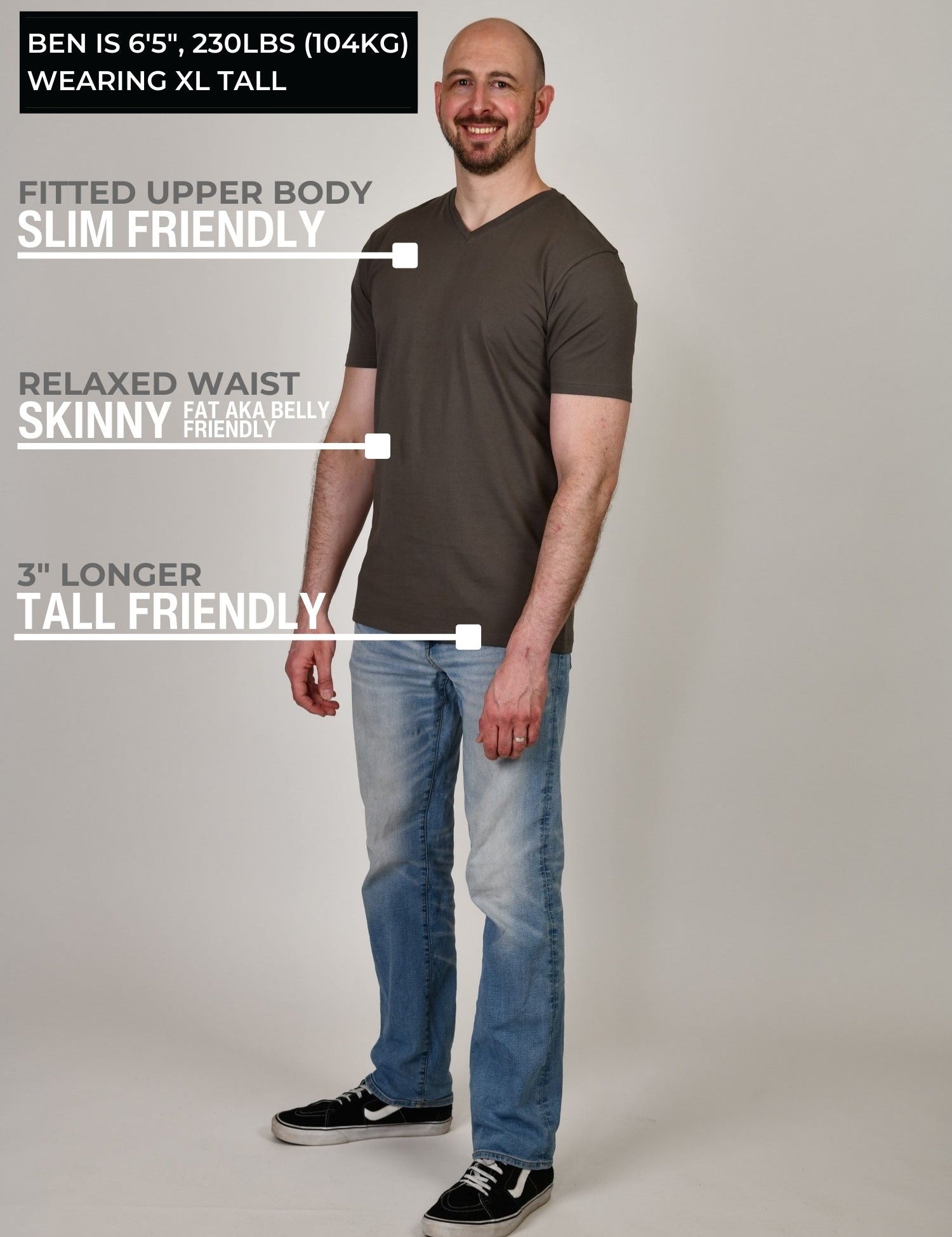 A head to toe shot of a tall and slim guy in the studio wearing a dark grey XL tall slim v-neck t-shirt.