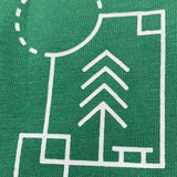 A close up shot of the graphic on the upper left chest of the t-shirt: a volleyball, a tree, a park bench, a rectangle and the Sun at the top left corner.