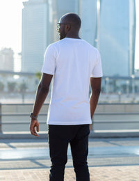 Thumbnail for A shot from behind of a tall skinny guy in the street and wearing a white tall slim fit t-shirt.