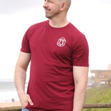 A tall slim guy wearing an XL tall graphic t-shirt with a tree design, looking to the left.