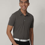 A tall skinny guy smiling and wearing a grey medium tall polo shirt.