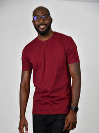Thumbnail for A tall and slim guy smiling in the studio and wearing a cabernet L tall slim t-shirt.