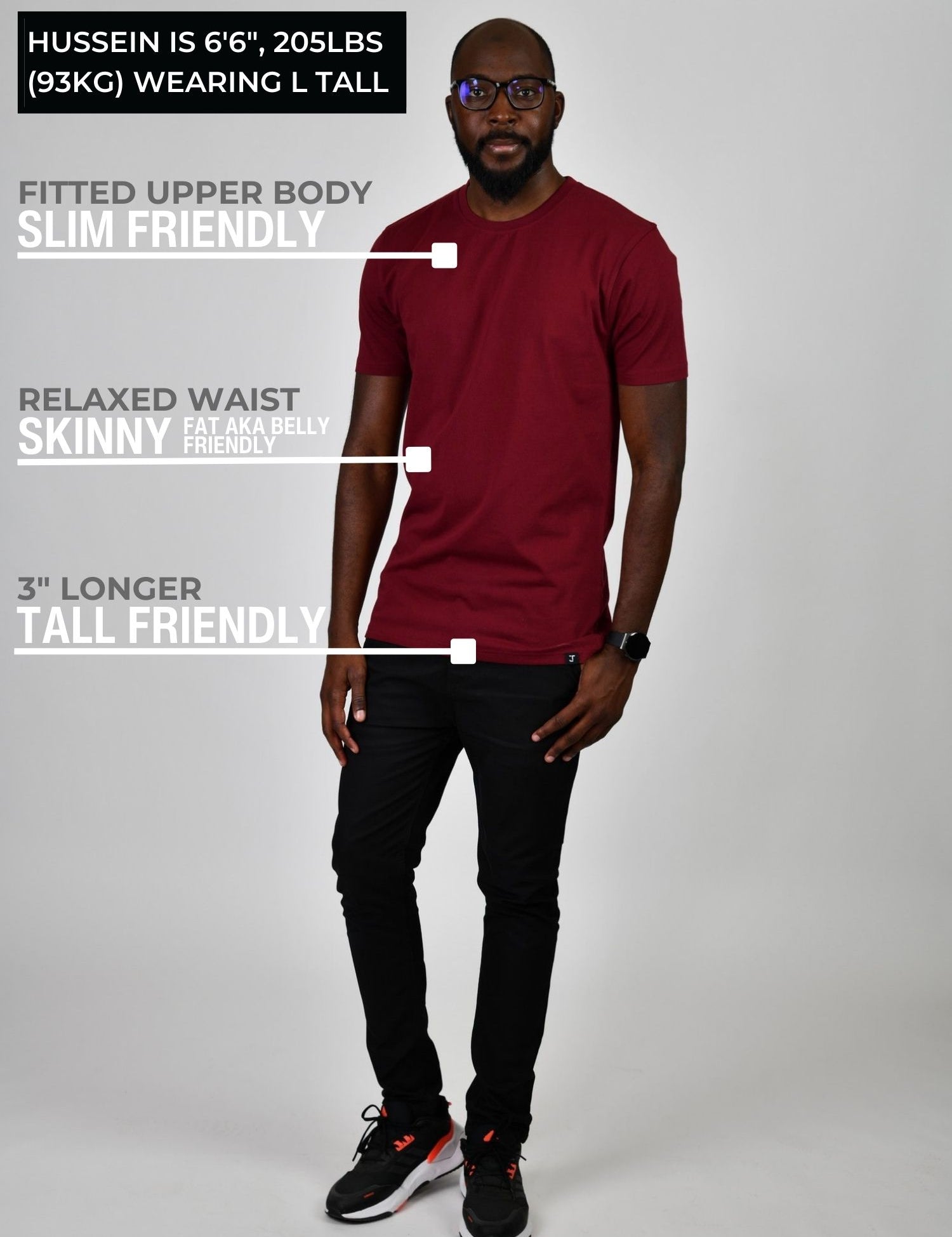 A head to toe shot of a tall athletic guy wearing a maroon large tall t-shirt.