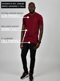 Thumbnail for A head to toe shot of a tall athletic guy wearing a maroon large tall t-shirt.