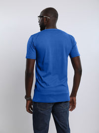 Thumbnail for A shot from behind of a tall and athletic guy in the studio wearing a blue large tall slim t-shirt.