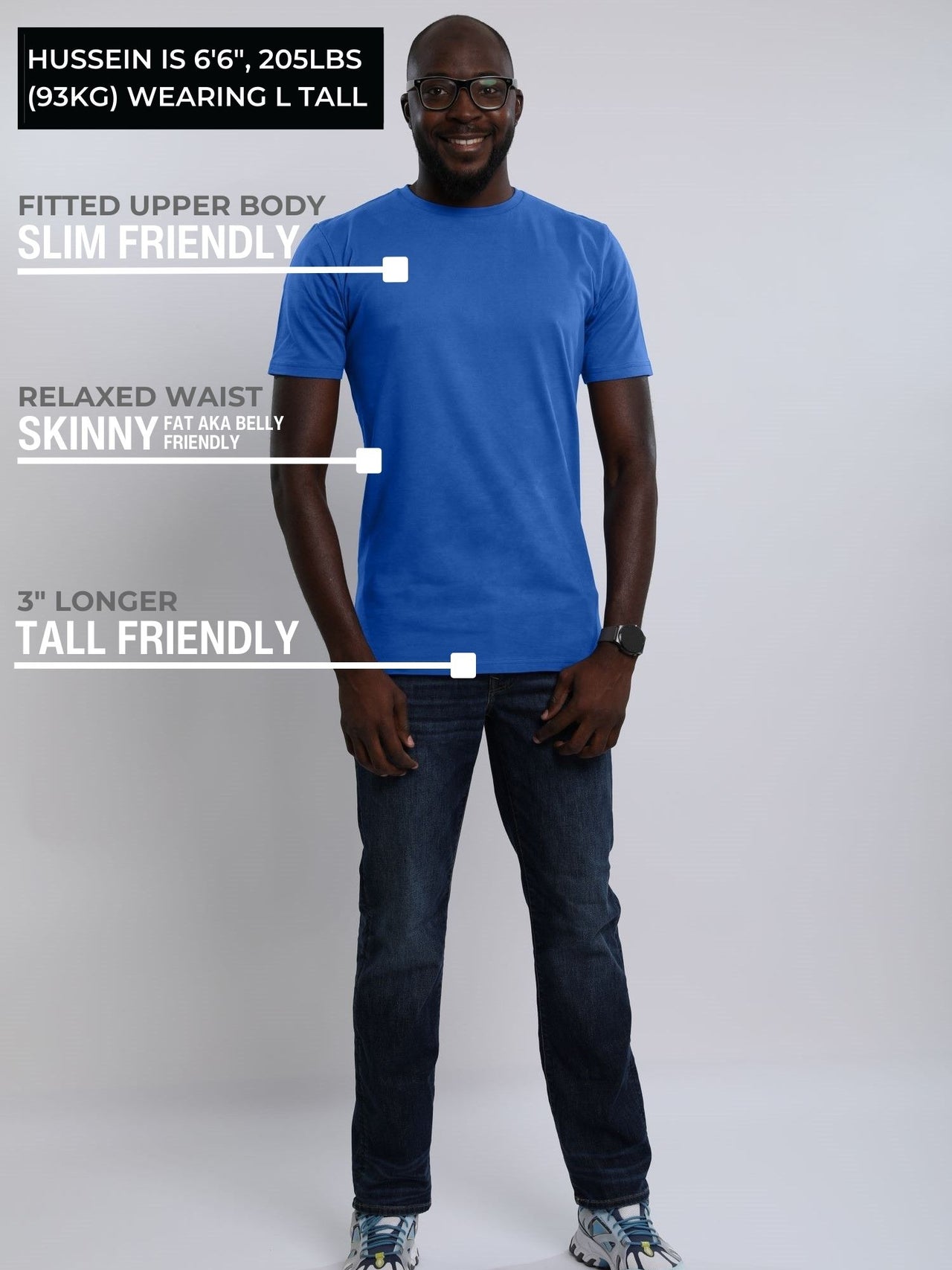 A head to toe shot of a tall athletic guy wearing a medium blue large tall t-shirt.