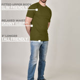 A head to toe shot of a tall athletic guy wearing a military green XL tall t-shirt.