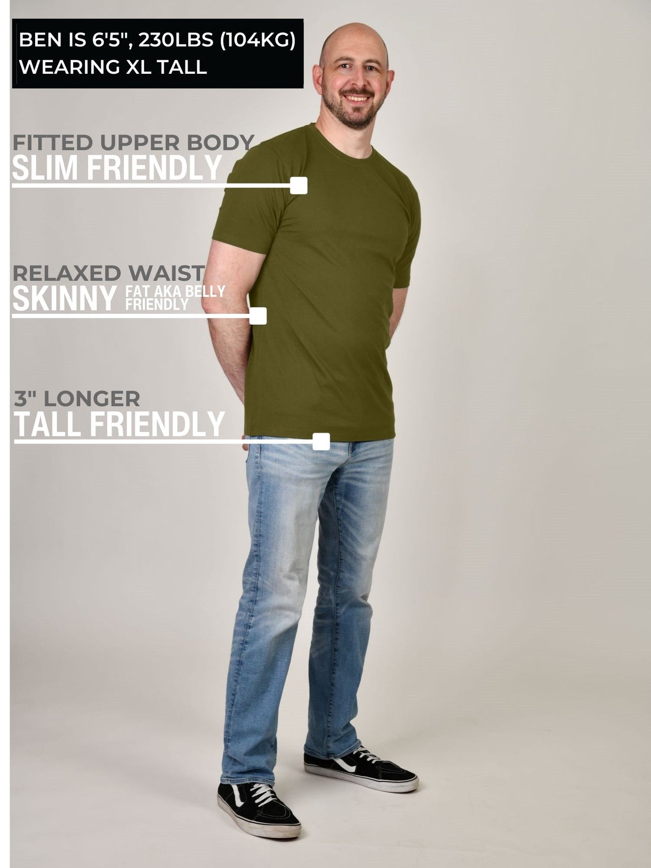 A head to toe shot of a tall athletic guy wearing a military green XL tall t-shirt.