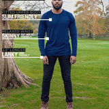 A head to toe shot of a tall athletic guy in a park wearing a navy long sleeve tall t-shirt.