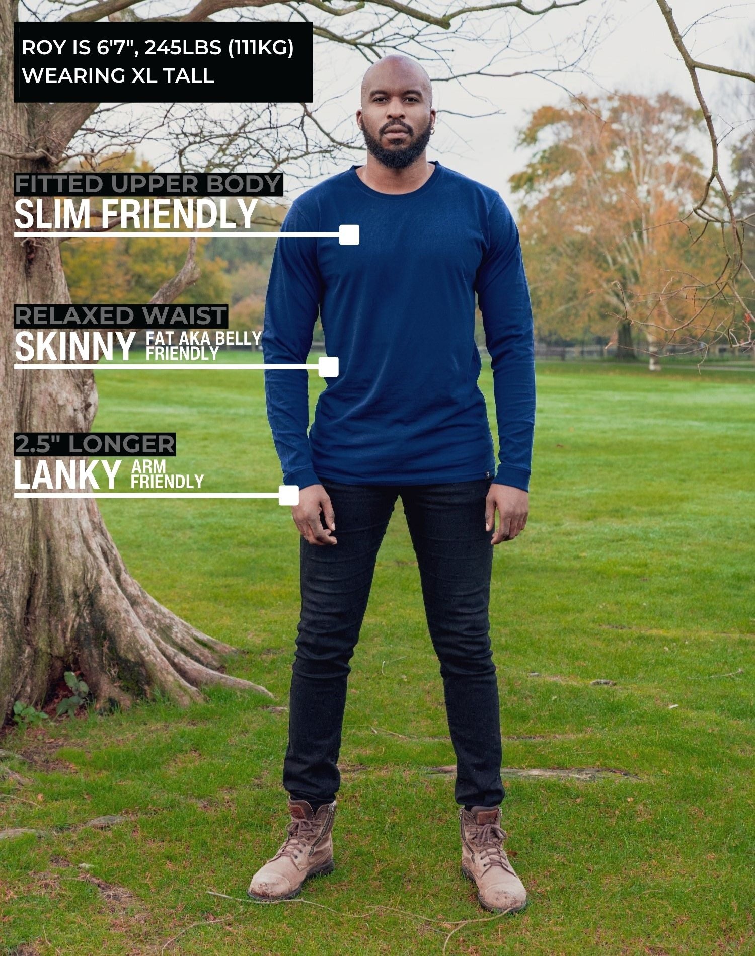 A head to toe shot of a tall athletic guy in a park wearing a navy long sleeve tall t-shirt.