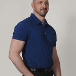 A tall lean guy, one hand in pocket, wearing a navy XL tall polo shirt.