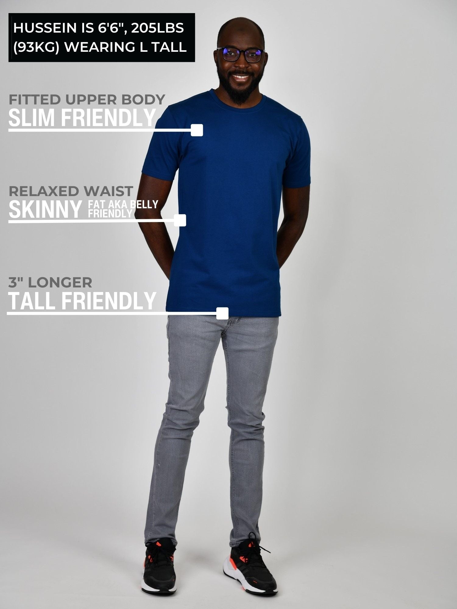 A head to toe shot of a tall athletic guy wearing a navy blue large tall t-shirt.