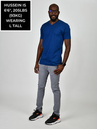Thumbnail for A head to toe shot of a tall and slim guy in the studio wearing a navy blue L tall slim v-neck t-shirt.
