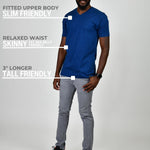 A head to toe shot of a tall and slim guy in the studio wearing a navy blue L tall slim v-neck t-shirt.