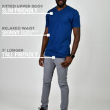 A head to toe shot of a tall and slim guy in the studio wearing a navy blue L tall slim v-neck t-shirt.