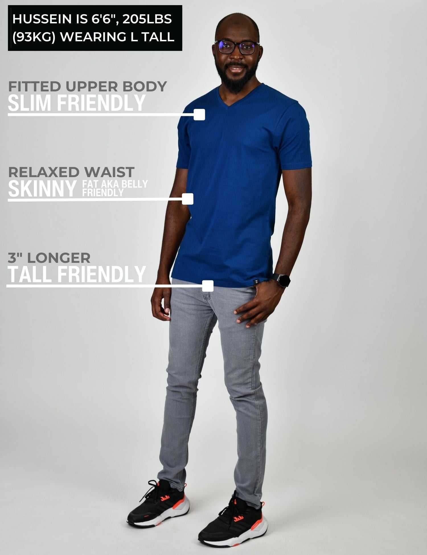 A head to toe shot of a tall and slim guy in the studio wearing a navy blue L tall slim v-neck t-shirt.