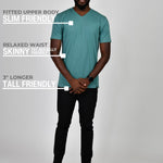 A head to toe shot of a tall and slim guy in the studio wearing a teal L tall slim v-neck t-shirt.