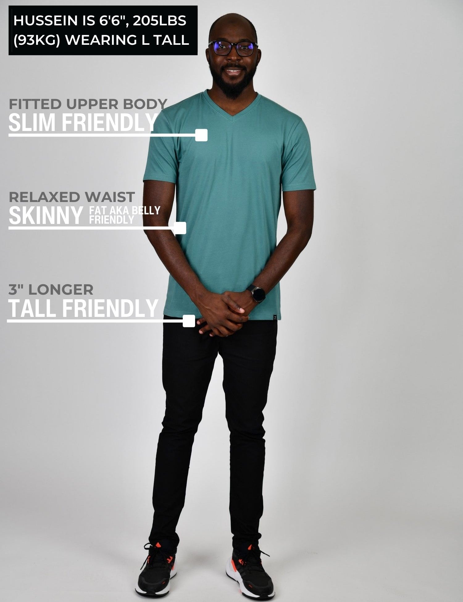 A head to toe shot of a tall and slim guy in the studio wearing a teal L tall slim v-neck t-shirt.