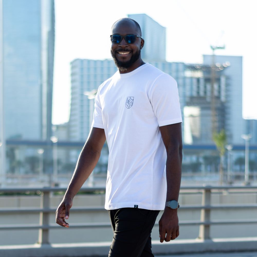 A tall skinny guy wearing a white tall graphic t-shirt.