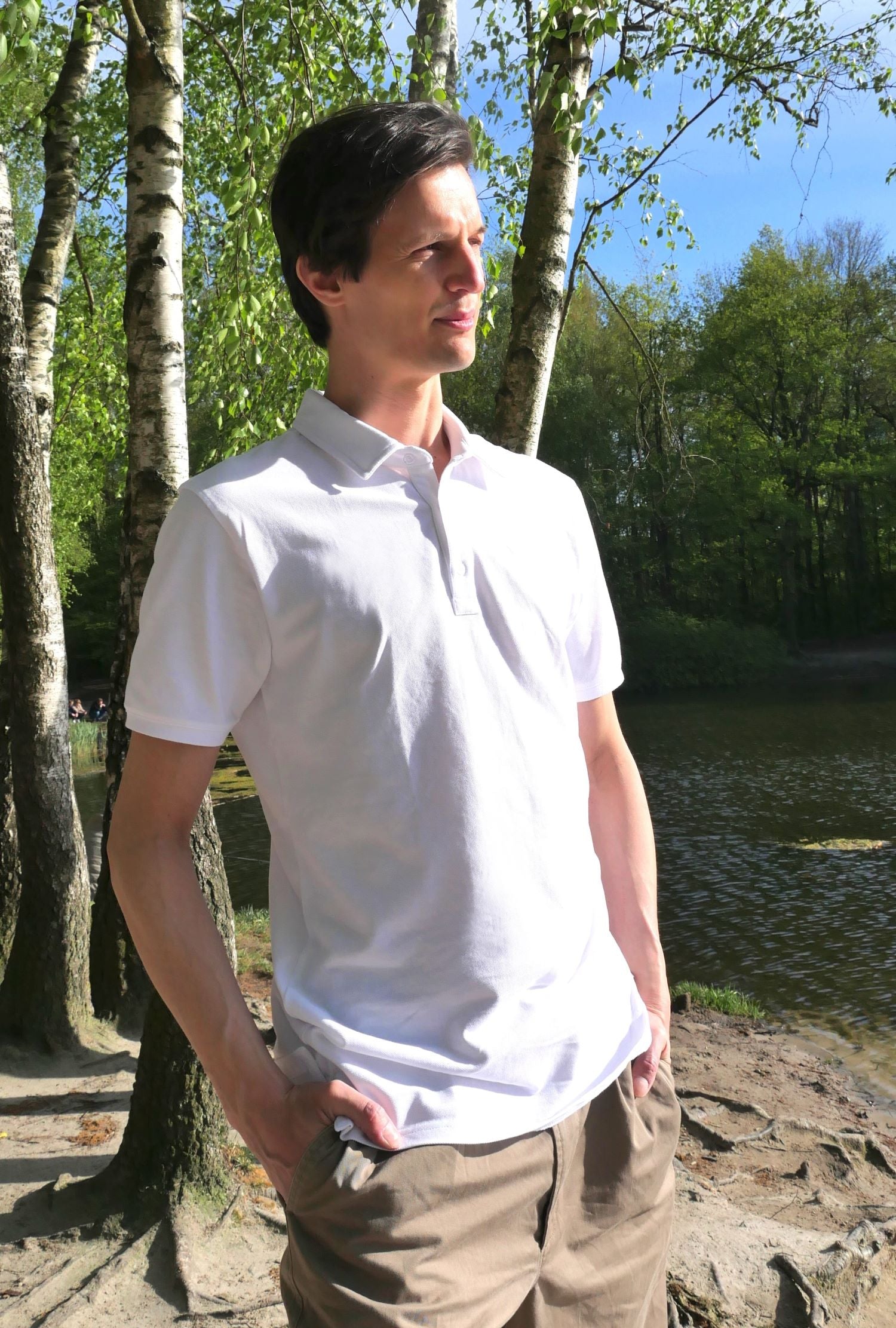 A tall skinny guy wearing a medium tall white polo shirt.