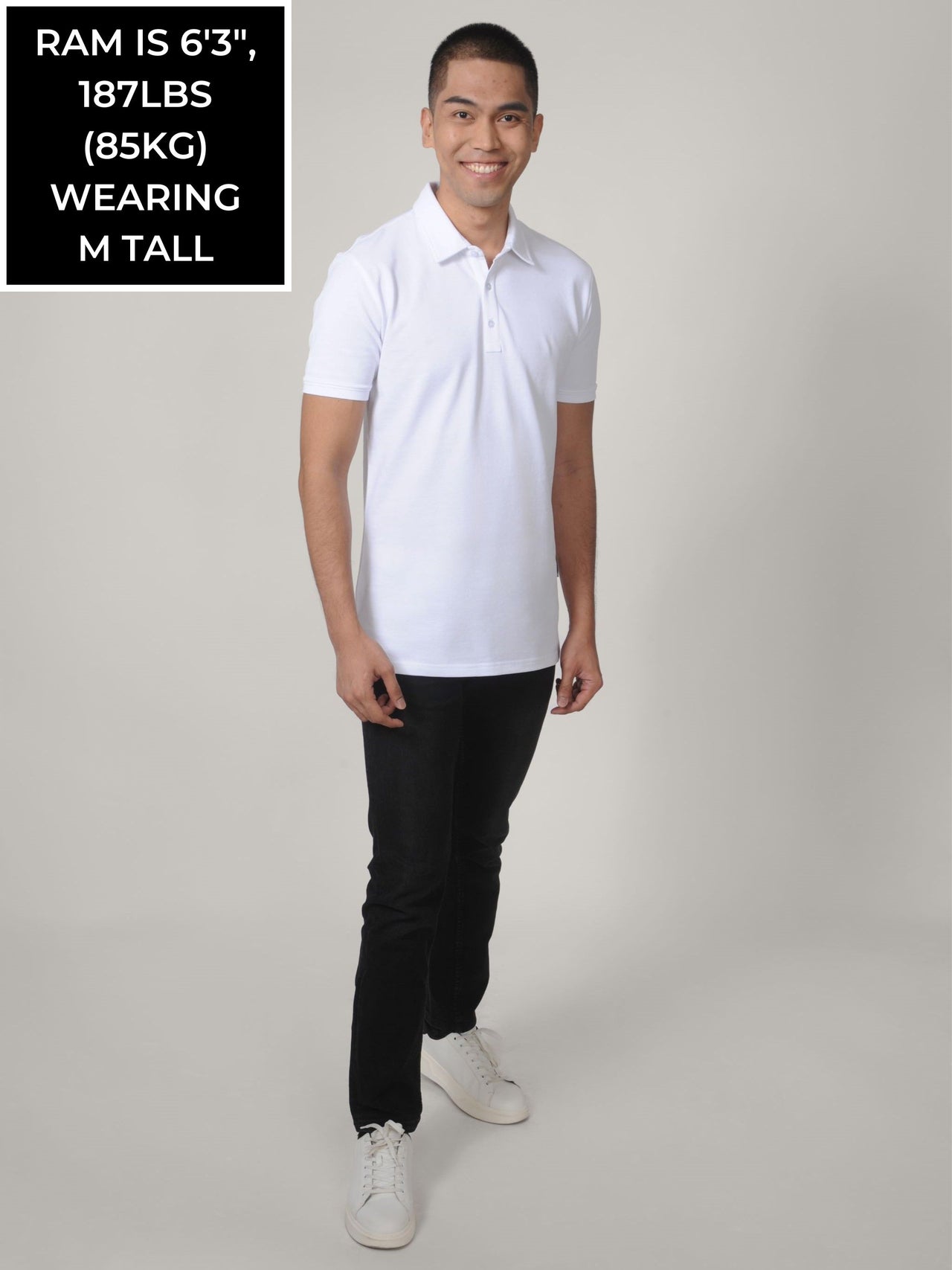 A head to toe shot of a tall skinny guy wearing a white tall polo shirt.