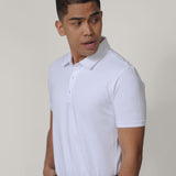 A tall skinny guy, one hand in pocket, wearing a white medium tall polo shirt.