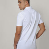 A shot from behind of a tall skinny guy wearing a tall white pique polo shirt.