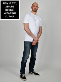 Thumbnail for A head to toe shot of a tall and slim guy in the studio wearing a white XL tall slim t-shirt.