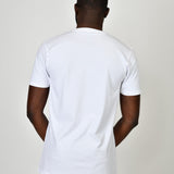 A shot from behind of a tall and slim guy in the studio and wearing a white L tall slim v-neck t-shirt.