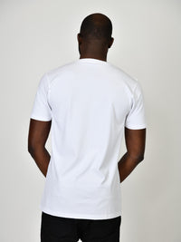 Thumbnail for A shot from behind of a tall and slim guy in the studio and wearing a white L tall slim v-neck t-shirt.