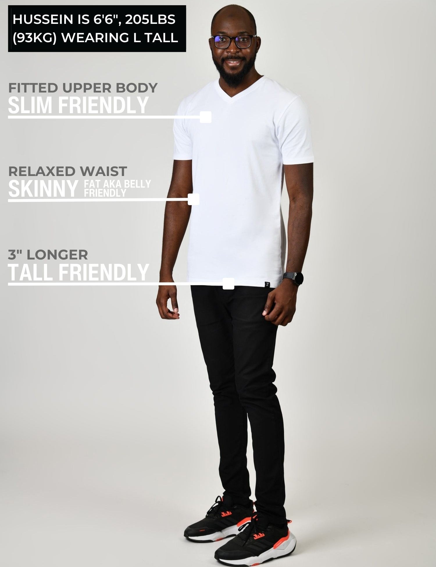 A head to toe shot of a tall and slim guy in the studio wearing a white L tall slim v-neck t-shirt.