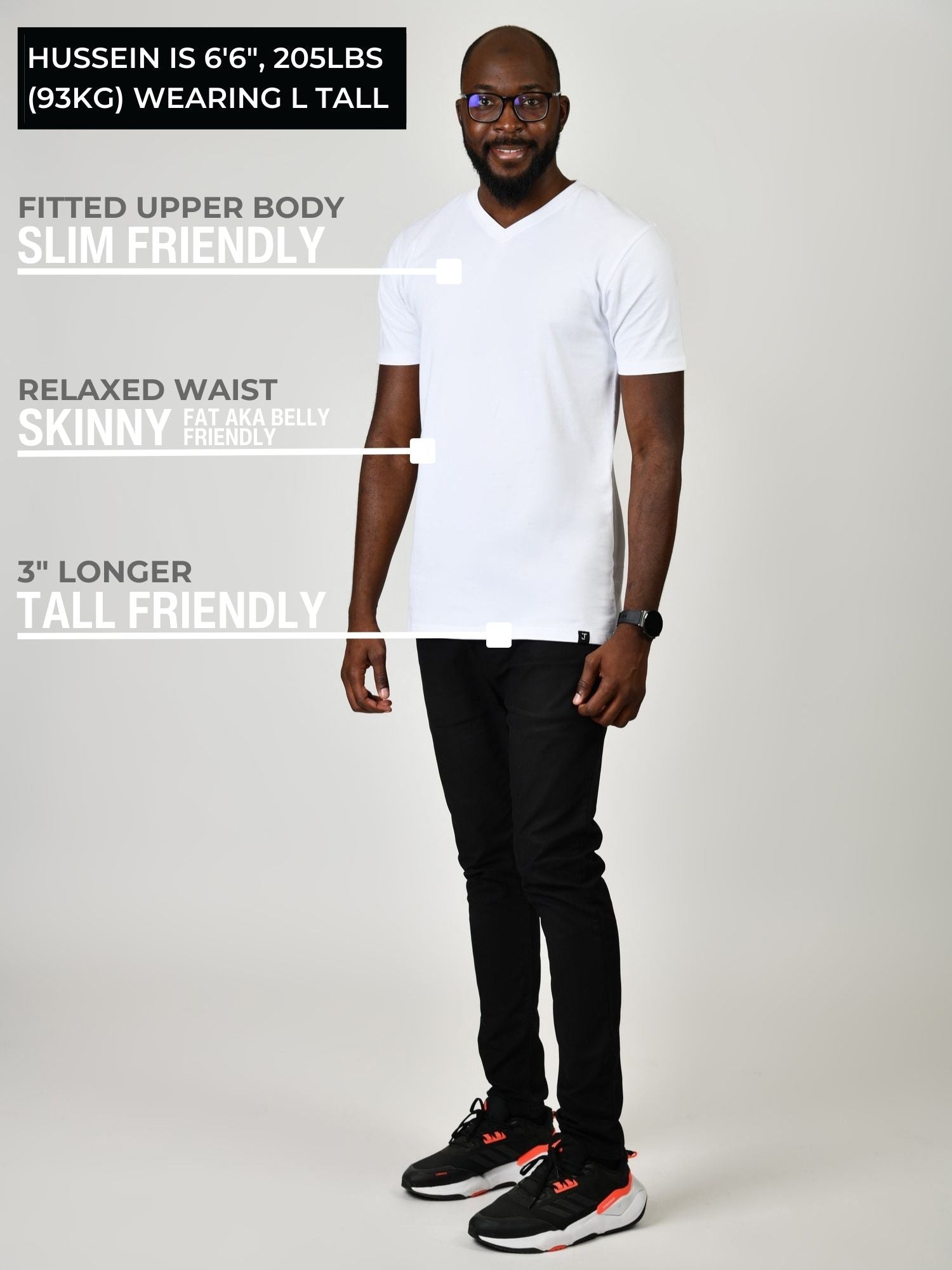 A head to toe shot of a tall and slim guy in the studio wearing a white L tall slim v-neck t-shirt.