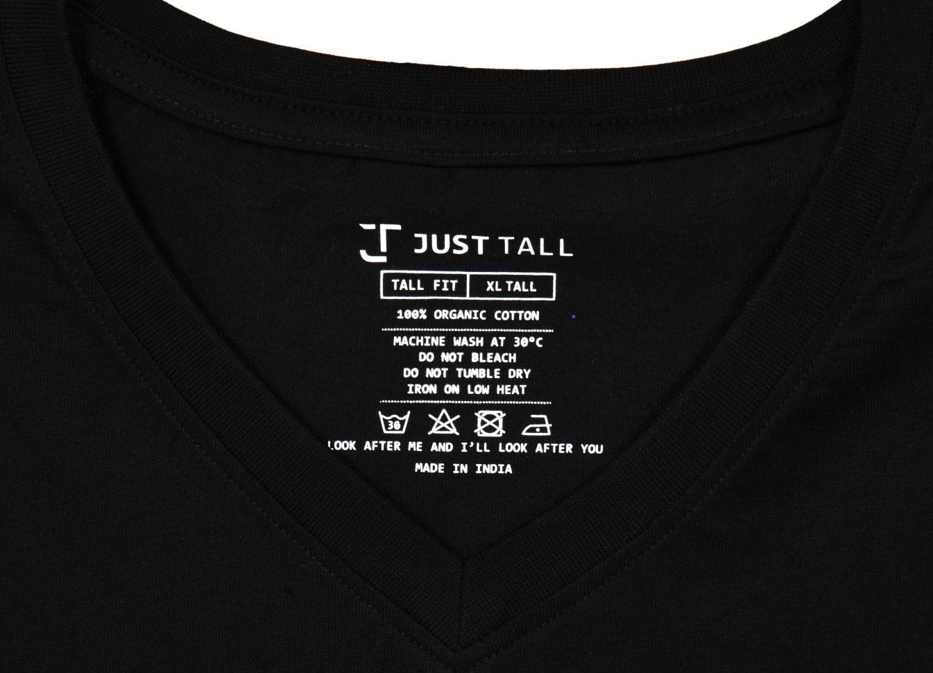 A close up of a tall V-neck and the Just Tall care instructions.